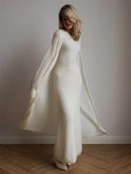 Woman in a white ribbed knit maxi dress and open-front long cardigan