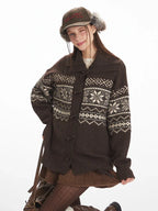 Close-up of a woman wearing a brown Fair Isle knit cardigan.