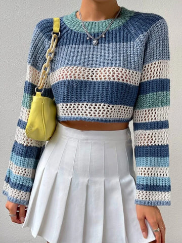 Woman wearing a blue, white, and green striped crochet knit cropped sweater with bell sleeves.