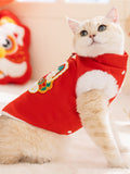 Side profile of a white cat wearing a festive red pet vest