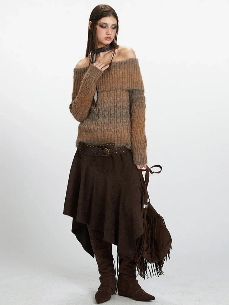 Full body shot of a woman in a brown and grey gradient off-the-shoulder knit sweater, brown skirt, belt, and boots.