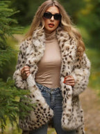 Woman wearing a spotted faux fur coat and sunglasses