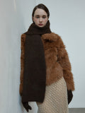 Close-up of a model wearing a textured brown knit scarf