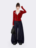 Full outfit of woman wearing red striped lapel cardigan with dark wide-leg jeans
