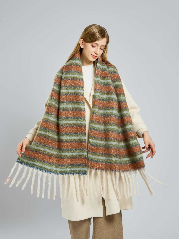 Full-body shot of a woman showcasing the length and texture of a striped winter scarf.