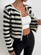 Woman modeling a black and white striped knit cardigan