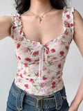 Front view of a woman wearing a white floral print top with ruffled off-the-shoulder cap sleeves and a sweetheart neckline with a pink ribbon tie.