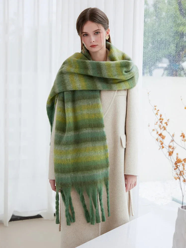 Full body shot of a woman modeling a green striped scarf with a beige coat