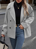 Front view of a woman in a grey wool blend pea coat, showcasing the double-breasted design and notch lapel.