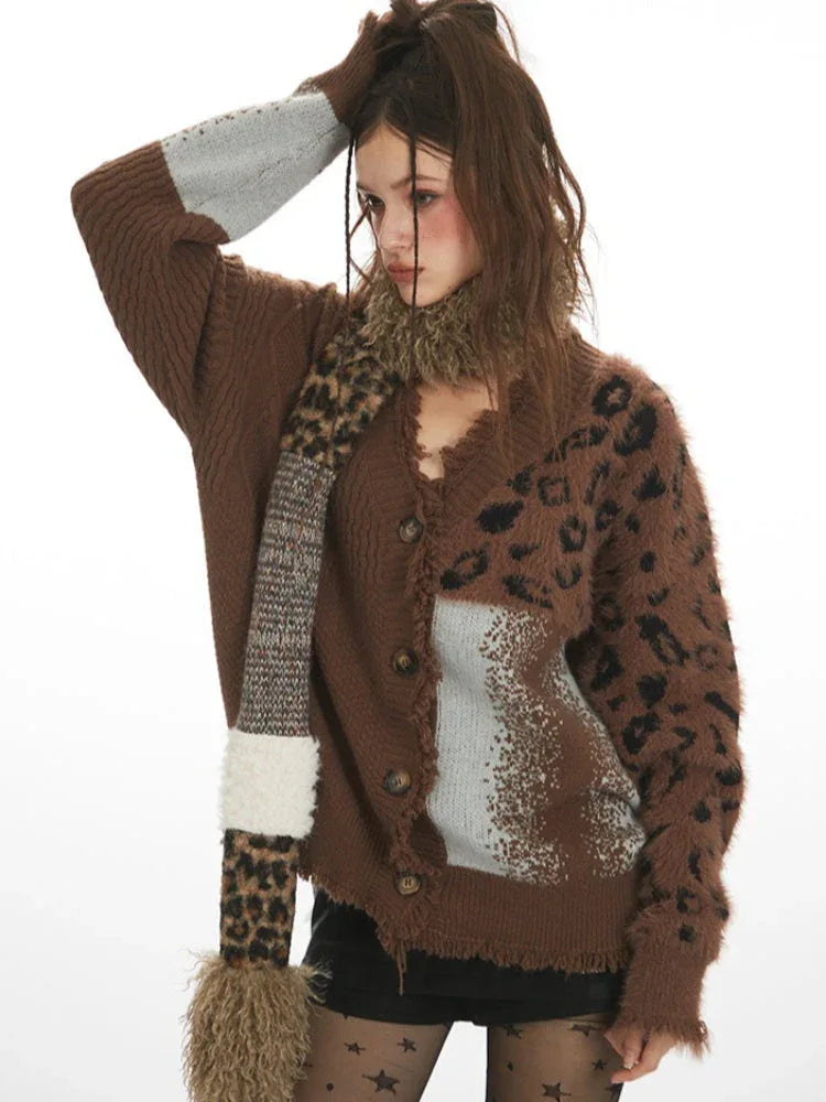 Woman posing with her hand on her head, showcasing a brown knit cardigan with contrasting fabric panels.
