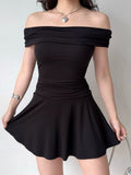 Model showcasing a black ruched off-the-shoulder dress