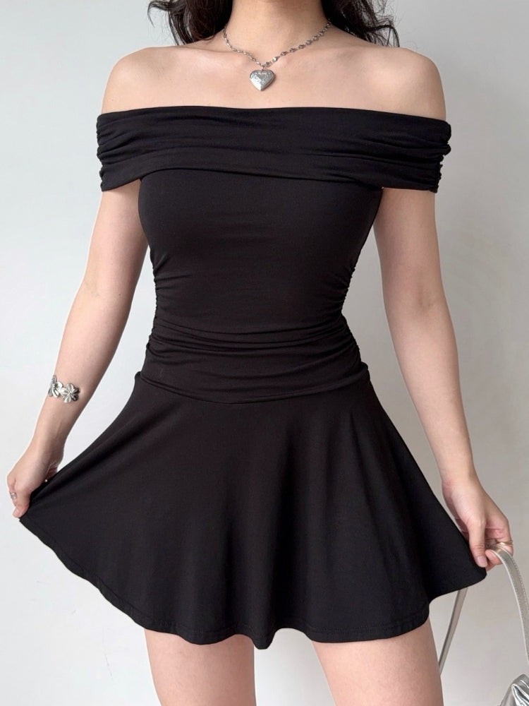 Model showcasing a black ruched off-the-shoulder dress