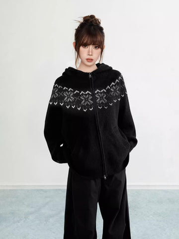 Woman wearing a black Fair Isle knit hoodie with snowflake pattern and zipper
