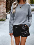 Back view of a grey cable knit sweater