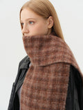 Detailed view of the high neck coverage provided by the tartan scarf