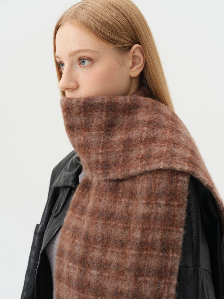 Detailed view of the high neck coverage provided by the tartan scarf