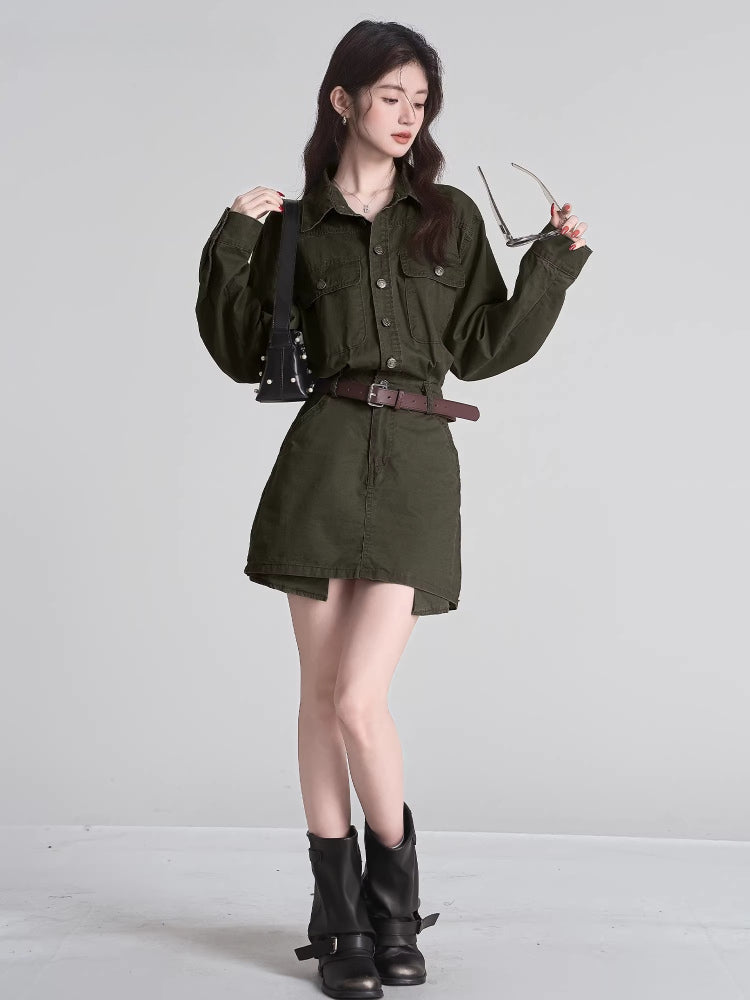 Woman posing with sunglasses and a black studded handbag, wearing an olive green dress.