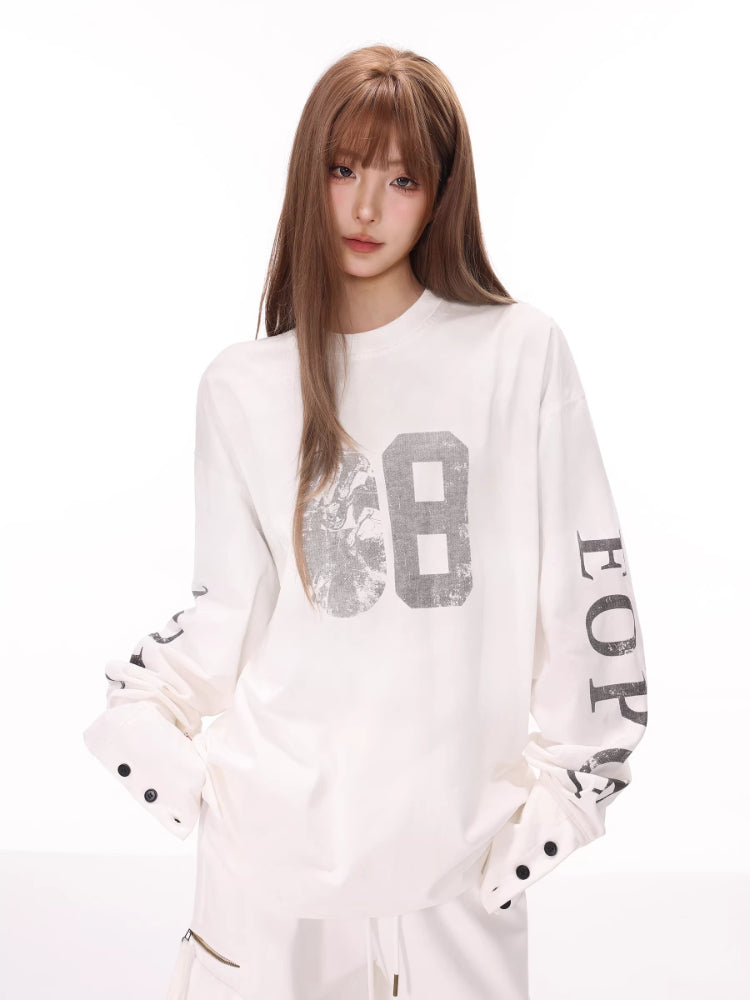 Model wearing a white long-sleeve graphic t-shirt with number '68' printed on the front and text on the sleeves.
