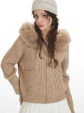 Front view of woman wearing beige faux fur hooded cardigan jacket with fur hood