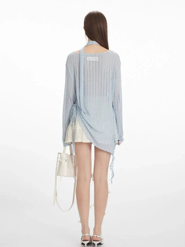 Back view of a light blue shimmer knit top with a lace detail on the back
