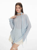 Close-up of the light blue shimmer knit top showing the fabric texture and scarf detail