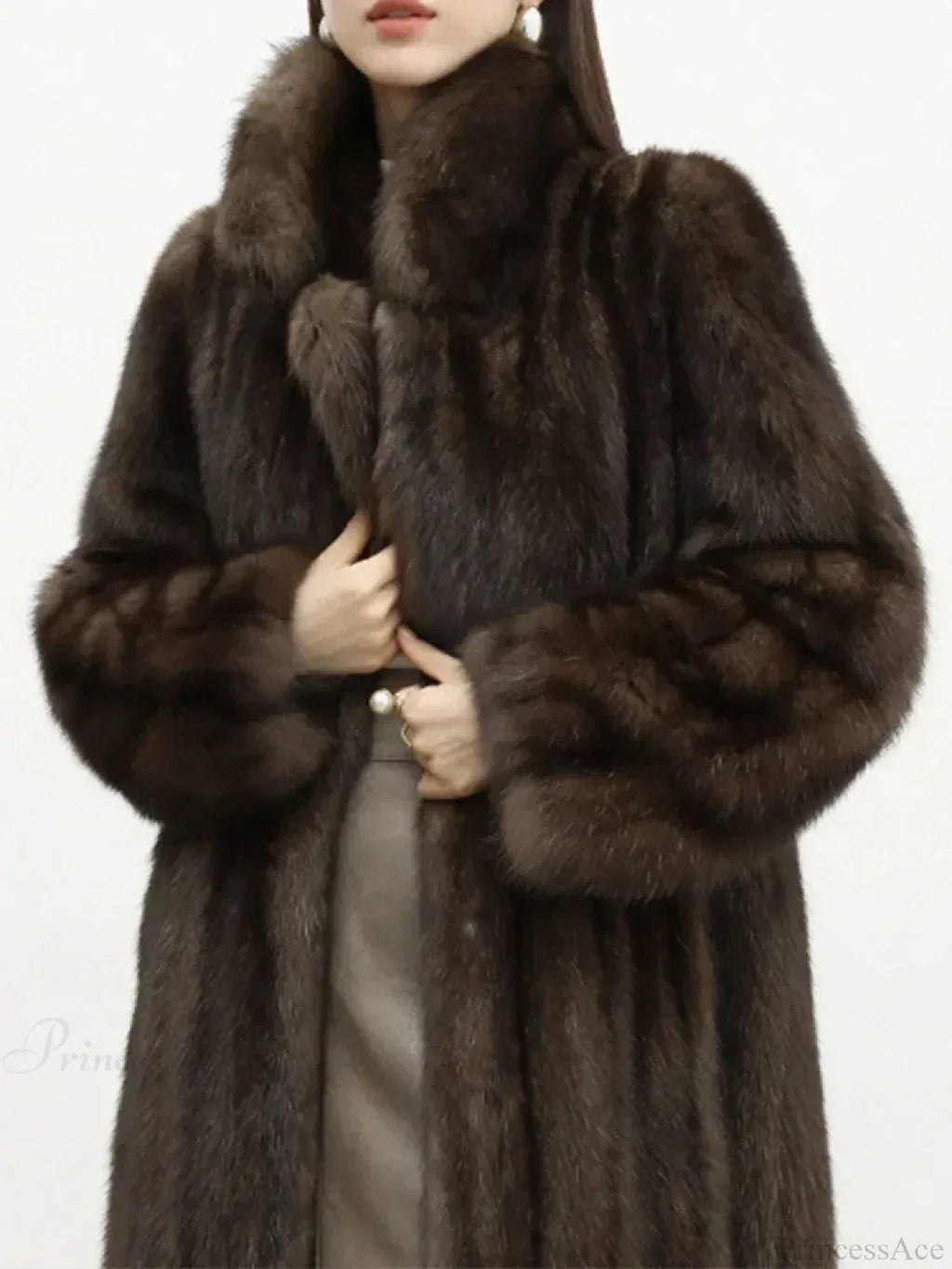 Close-up of a woman wearing a brown mink fur coat, showing the texture of the fur and the notched collar.