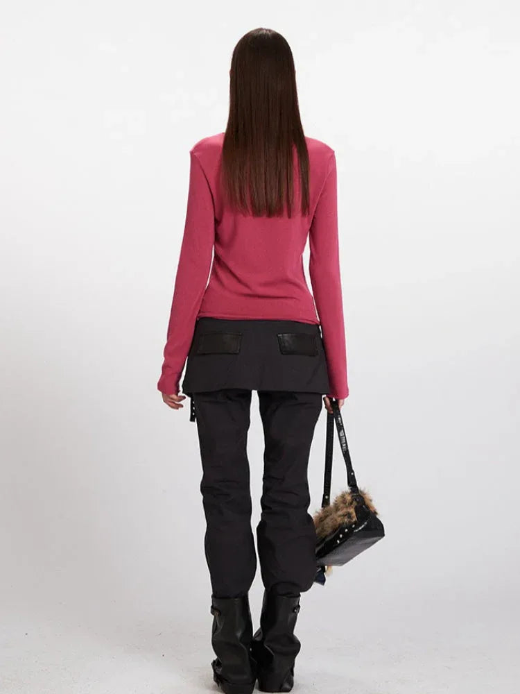 Back view of a woman in a fitted rose red long sleeve top