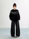 Woman wearing a grey Fair Isle knit hoodie with snowflake pattern and zipper
