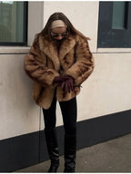 close-up of a woman wearing a textured brown faux fur jacket