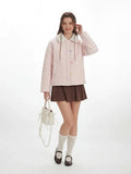 Front view of a woman in a pink quilted jacket, brown skirt, and white socks.