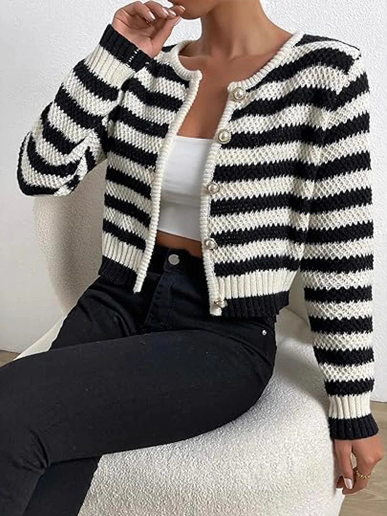 Front view of a black and white striped cropped cardigan
