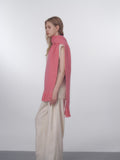 Side view of a woman styled with a long pink scarf