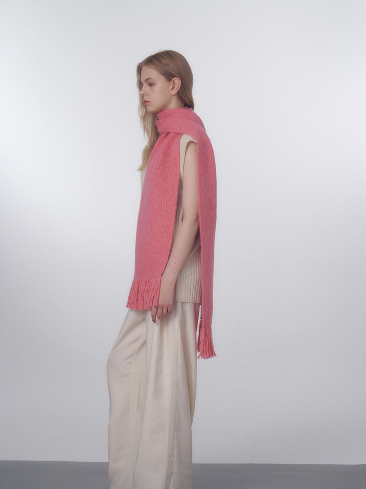 Side view of a woman styled with a long pink scarf