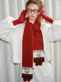 Woman wearing a festive red knit scarf with a cartoon snowman design