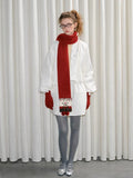 Model showing the length and versatility of the knit snowman scarf