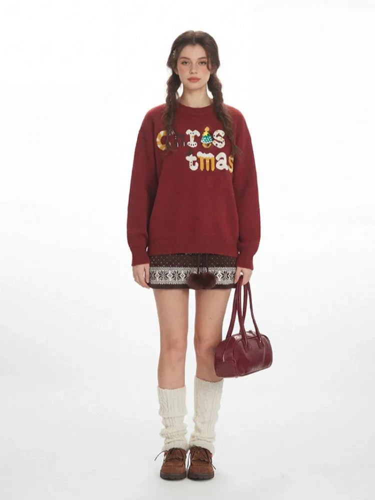 Woman in a festive red oversized knit sweater with 'Christmas' graphic
