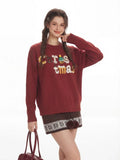 Model posing with a burgundy handbag and cream leg warmers