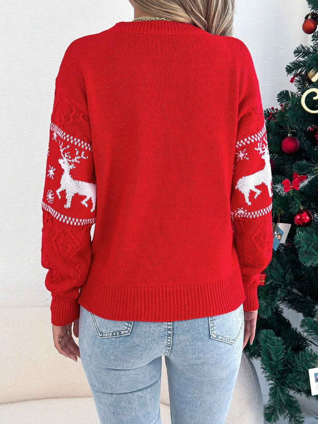 Back view of a red festive knit sweater with reindeer and snowflake pattern