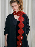 Full body shot of a model with the red circular knit scarf