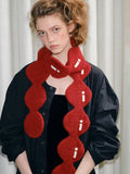 Close-up of the red textured knit scarf with white stitching