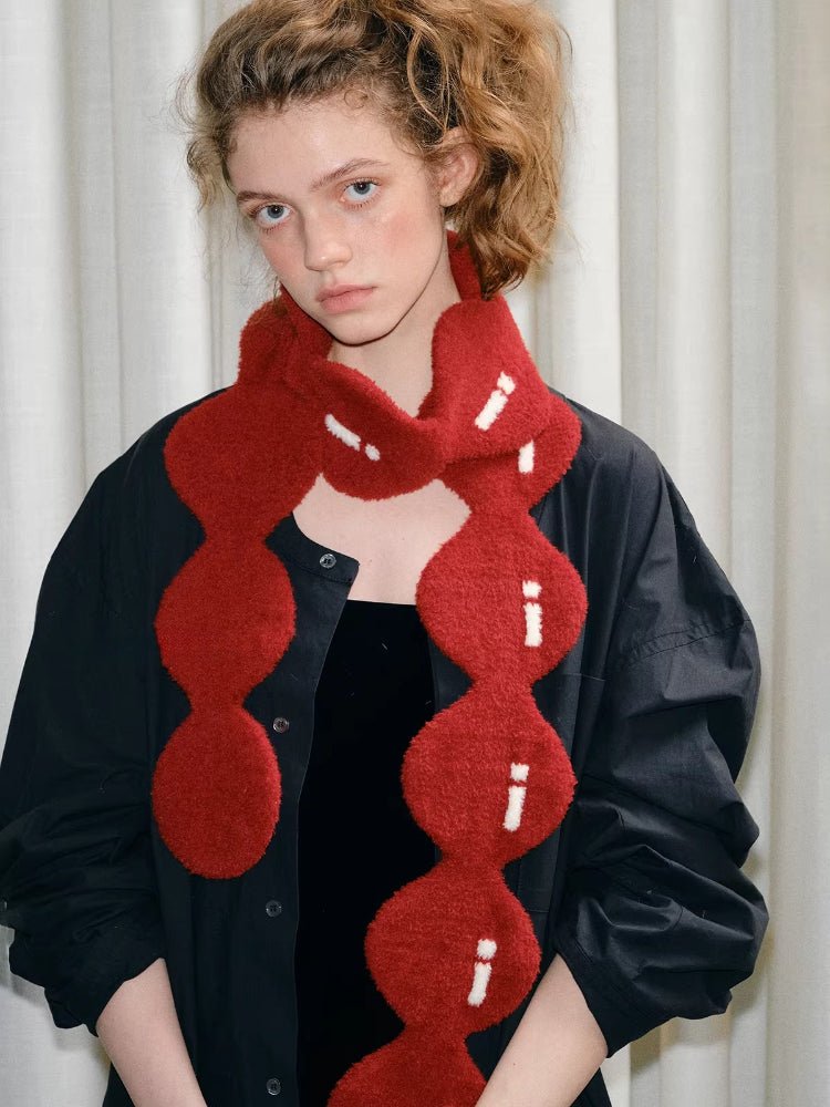 Close-up of the red textured knit scarf with white stitching