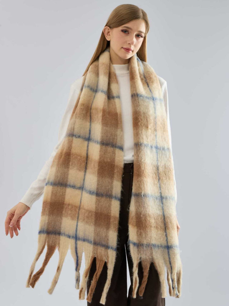 Woman showcasing the length and texture of a plaid scarf