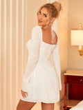 Back view of a woman in a white fit-and-flare dress with a square neckline.