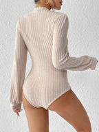 Close-up of the ribbed texture and puff sleeve detail on a cream bodysuit