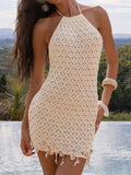 Front view of a cream knit halter mini dress with a diamond pattern and beaded hem
