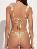 Back view of a woman wearing a multicolor gingham bikini with adjustable back tie and thong bottom.