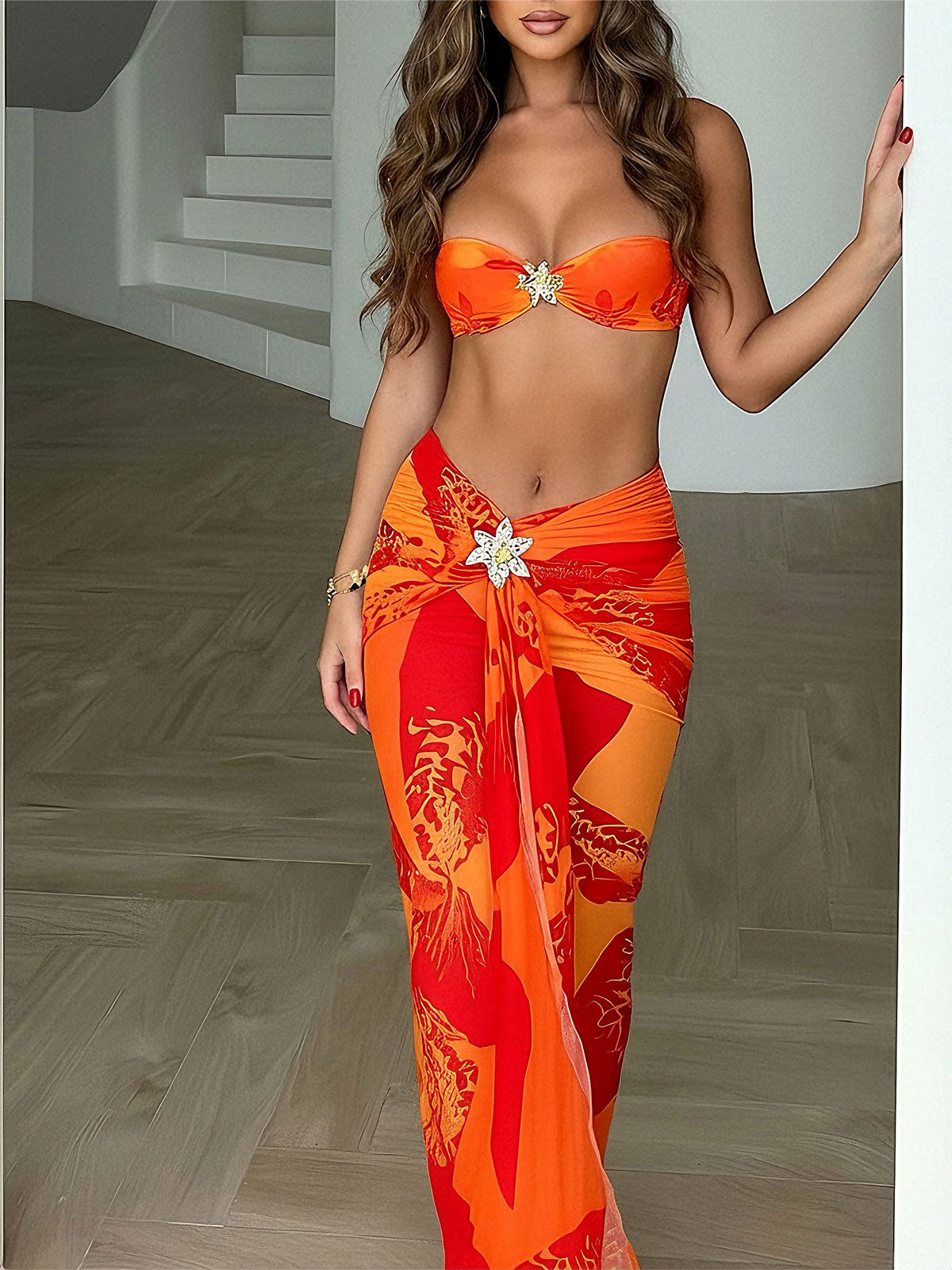 Woman wearing a strapless orange bikini top and a matching floral print maxi sarong
