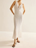 Woman wearing a white sleeveless maxi knit dress with a keyhole neckline