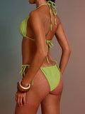 Side view of a woman wearing a lime green triangle bikini with gold hardware