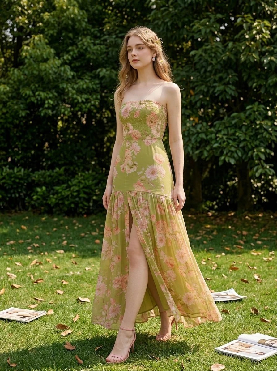 Woman in a green floral print strapless maxi dress walking in a grassy outdoor setting
